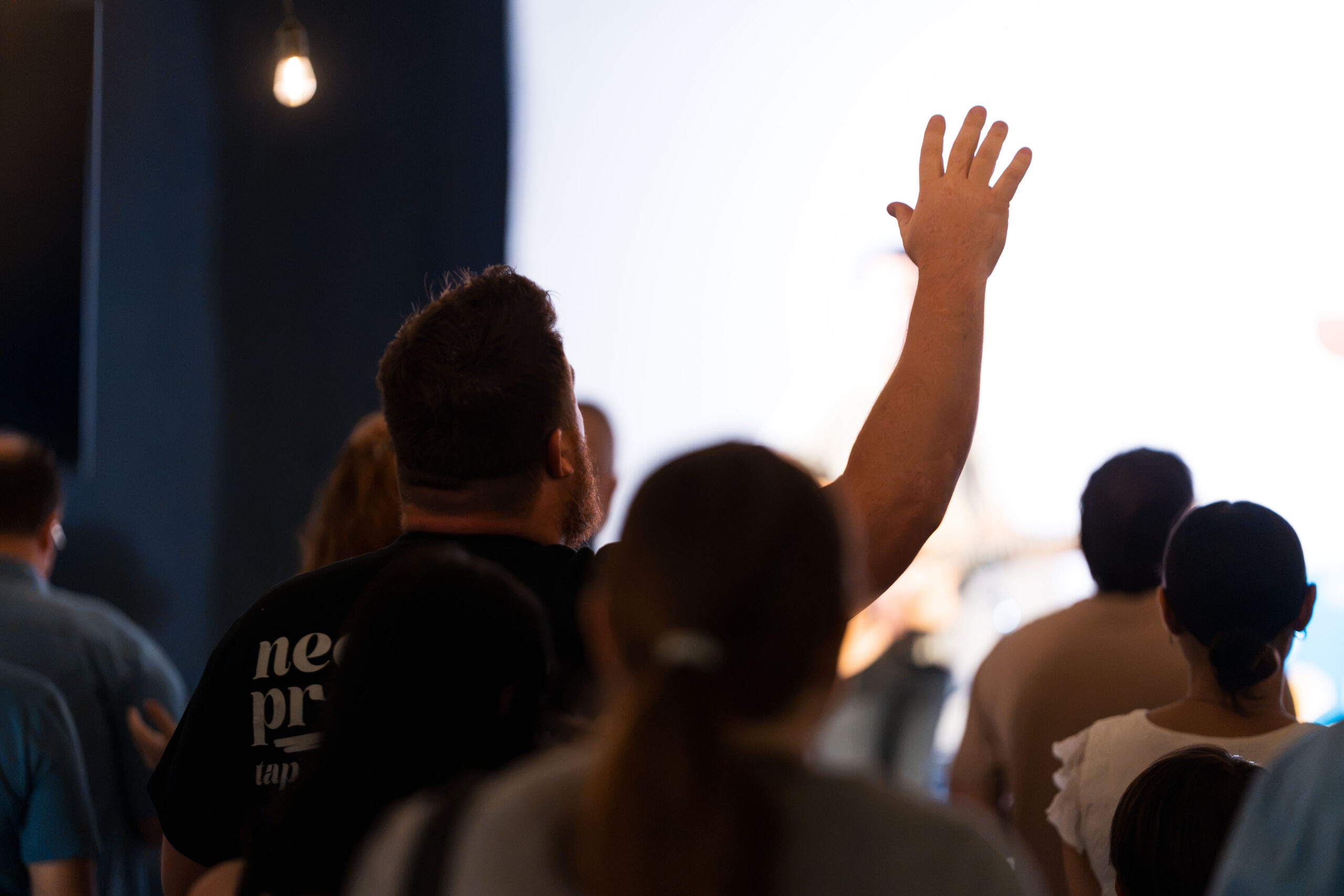 A hand raised in worship at Passion Creek